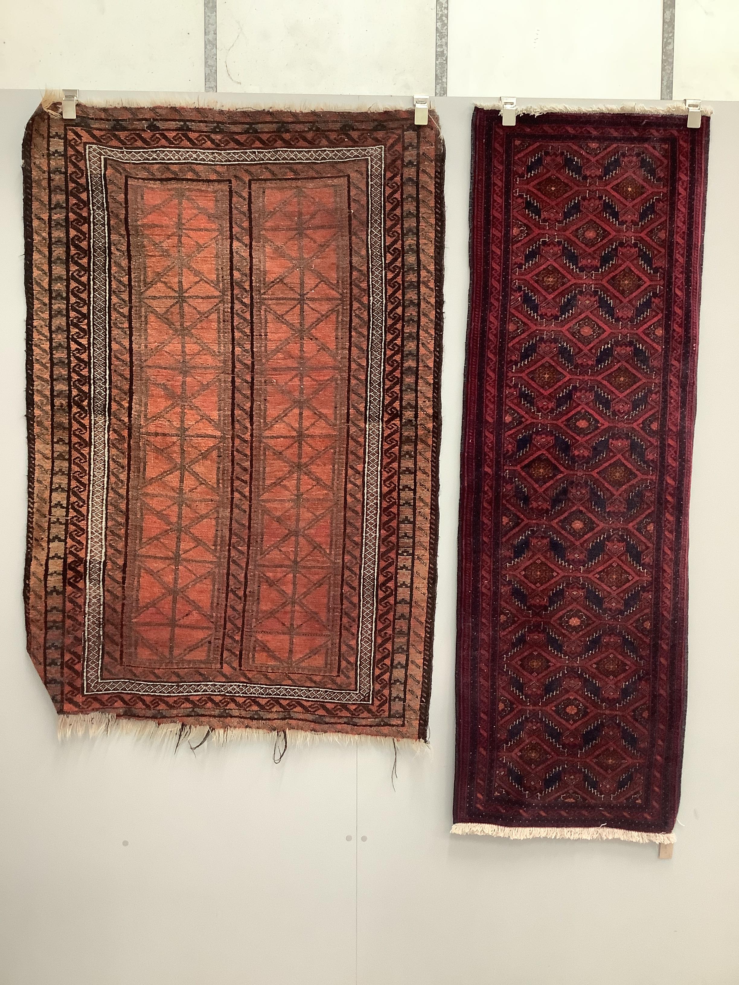 A Belouch red ground rug and a runner, larger 155 x 106cm